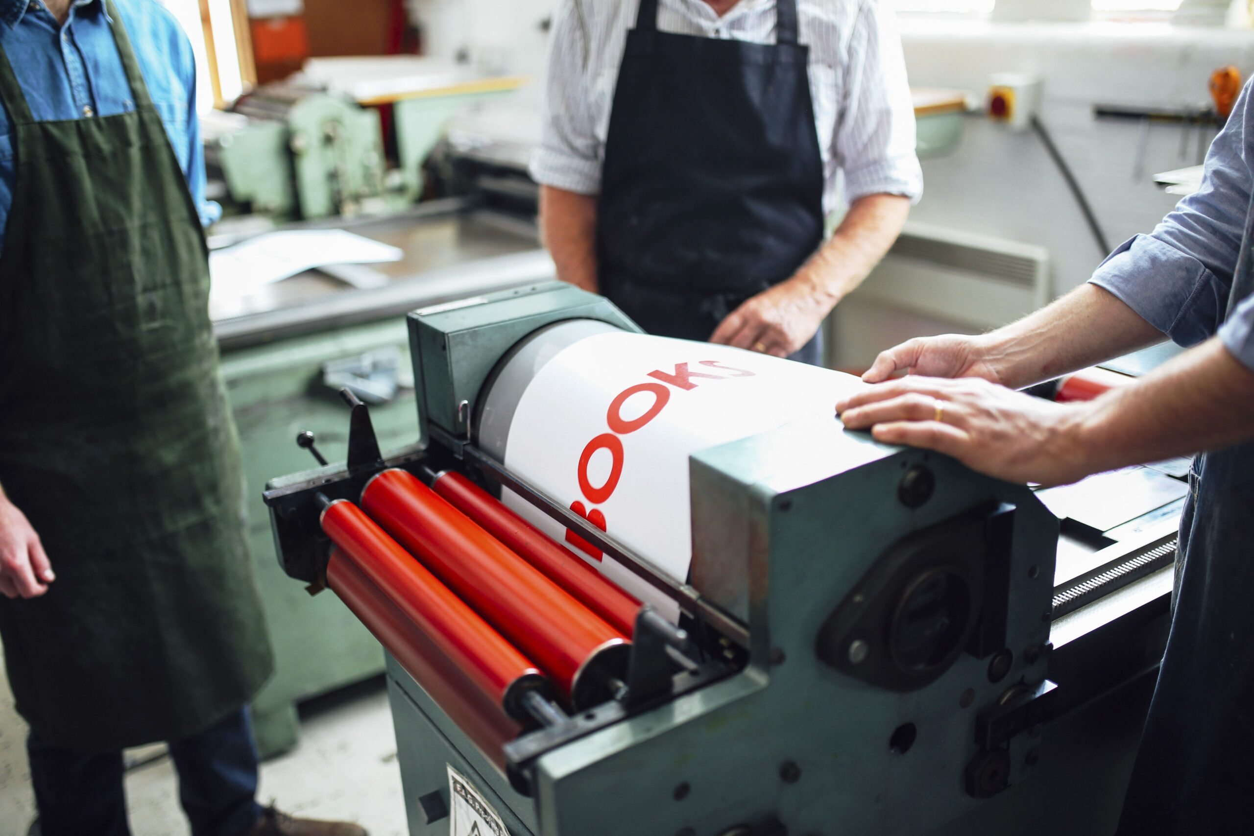 craftspeople-being-shown-how-to-use-letterpress-ma-2024-06-19-19-48-31-utc-min